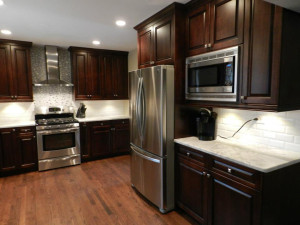 Dark Wood Cabinets and Marble Counter Tops