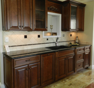 Dark Wood Cabinet Kitchen with Black Marble Counter Tops
