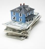 Image of blue home ontop of cash